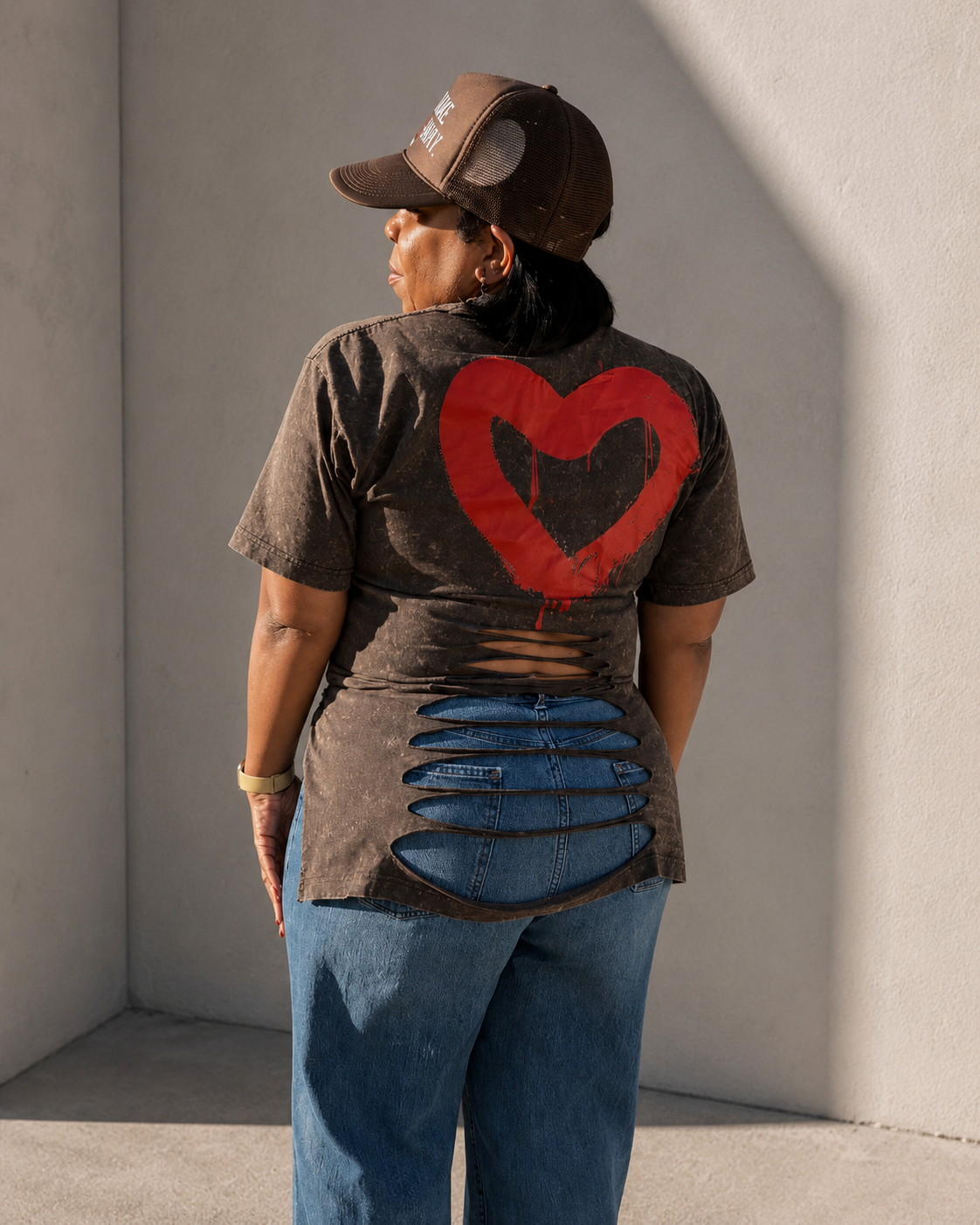 God & Grit acid-wash t-shirt with a large red heart graphic and distressed cutout back detail worn with blue jeans