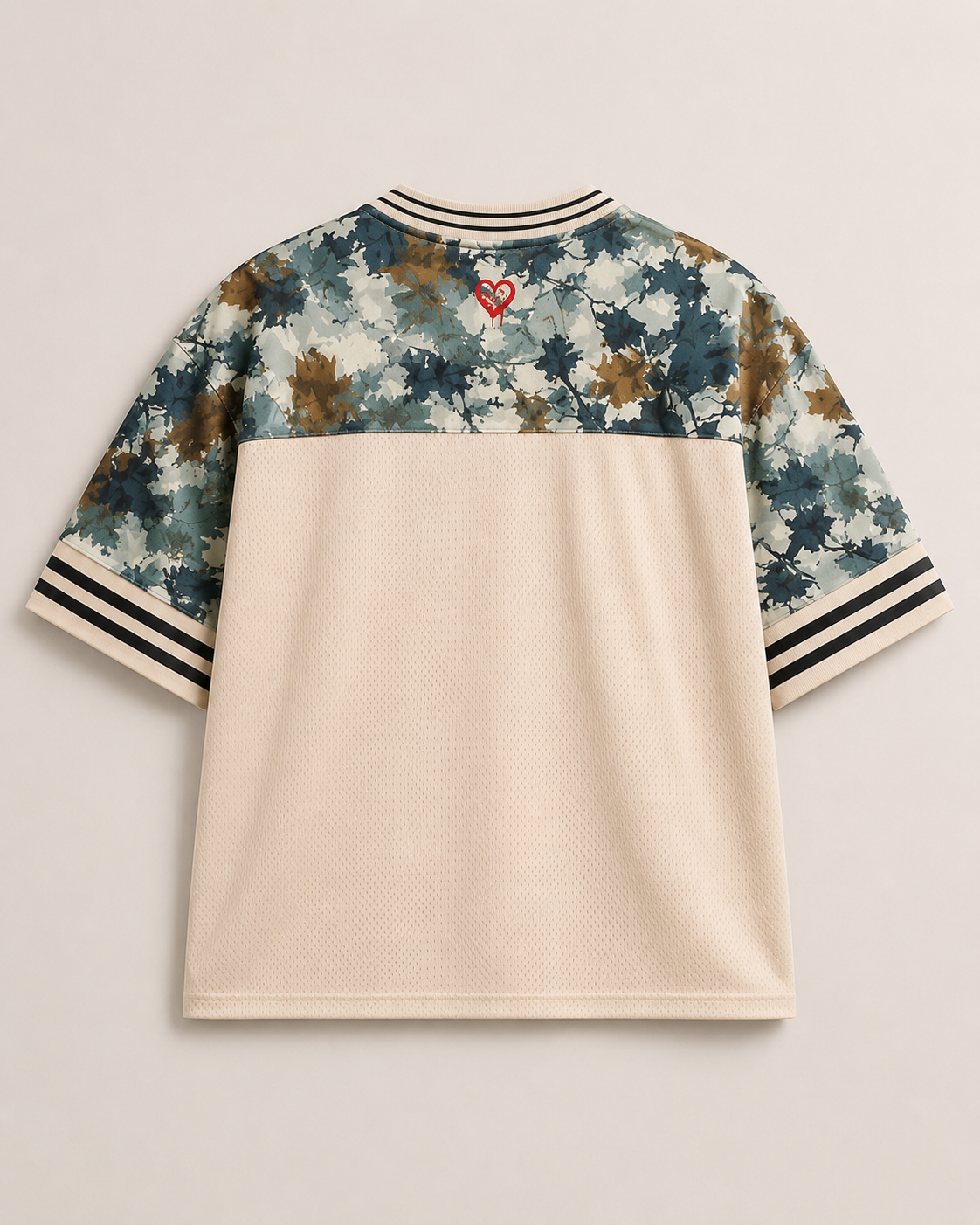 God & Grit oversized mesh jersey shirt in beige with camouflage sleeves, striped trim, and a small red heart graphic.